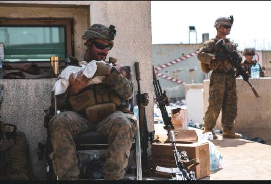 American Soldier taking care of a child