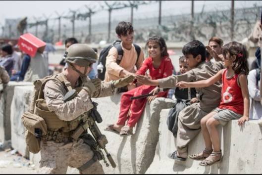 American soldier playing with afghan kids